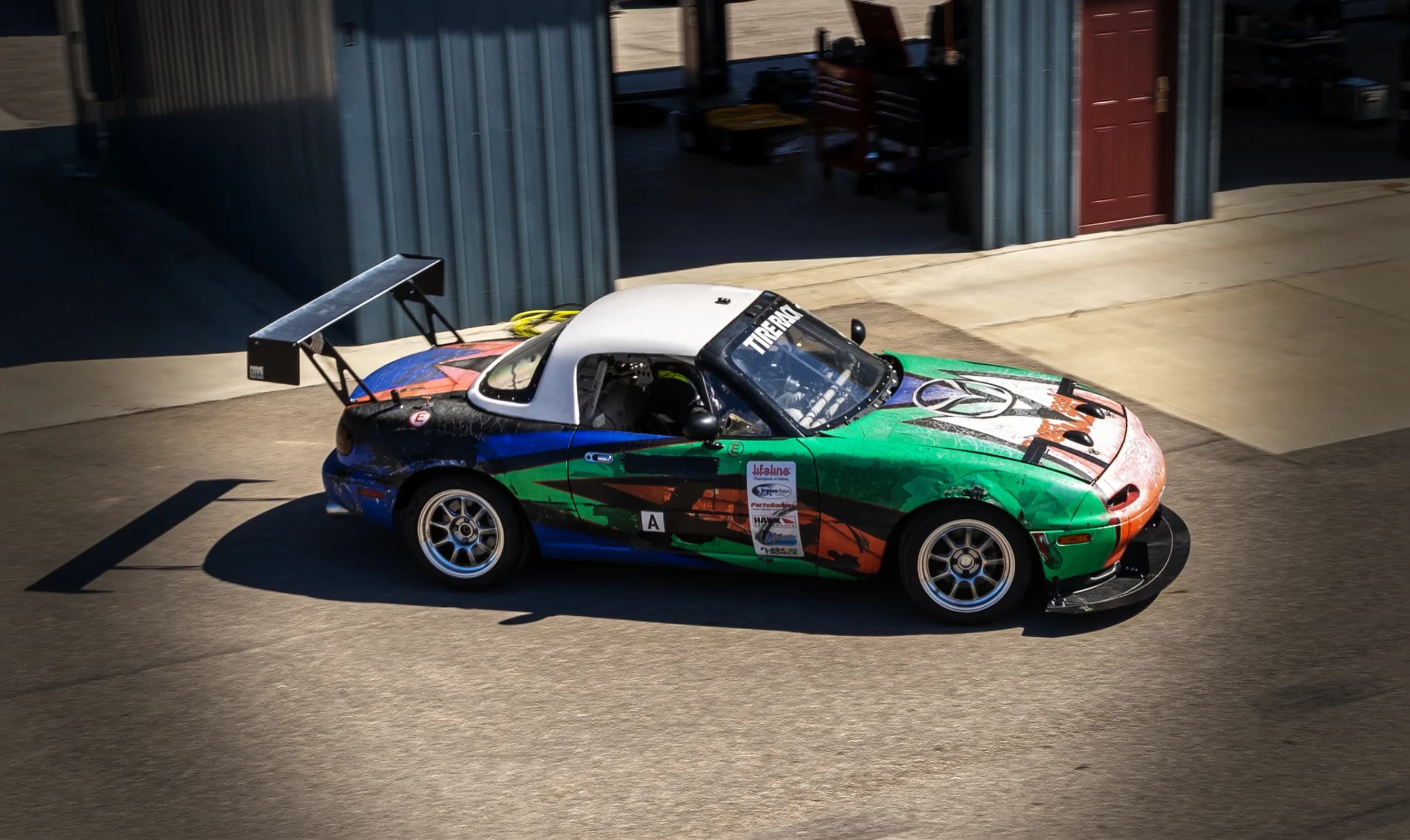 Eighty Six Pieces Racing endurance Miata in the paddock