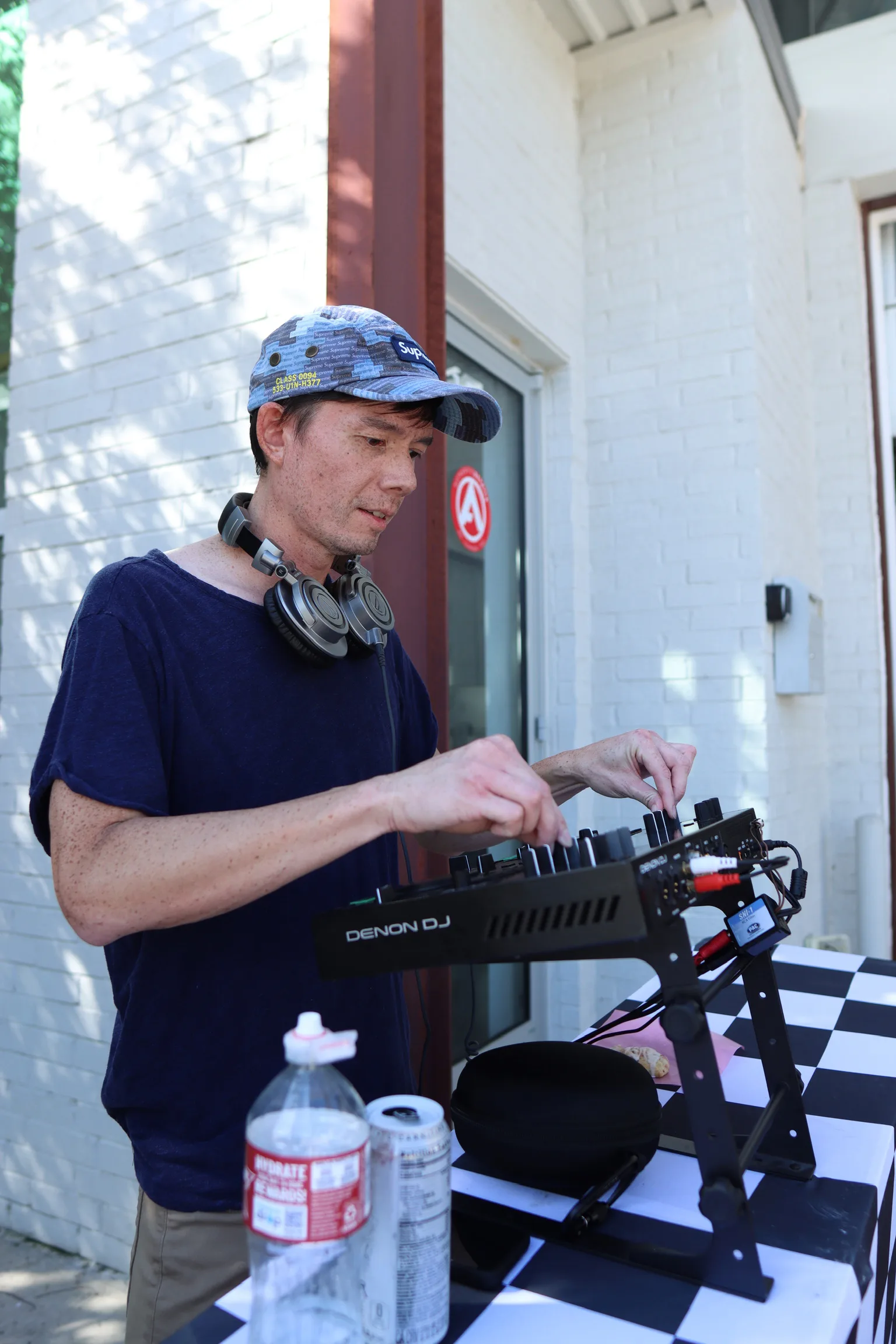 DJ setting up music at the meet