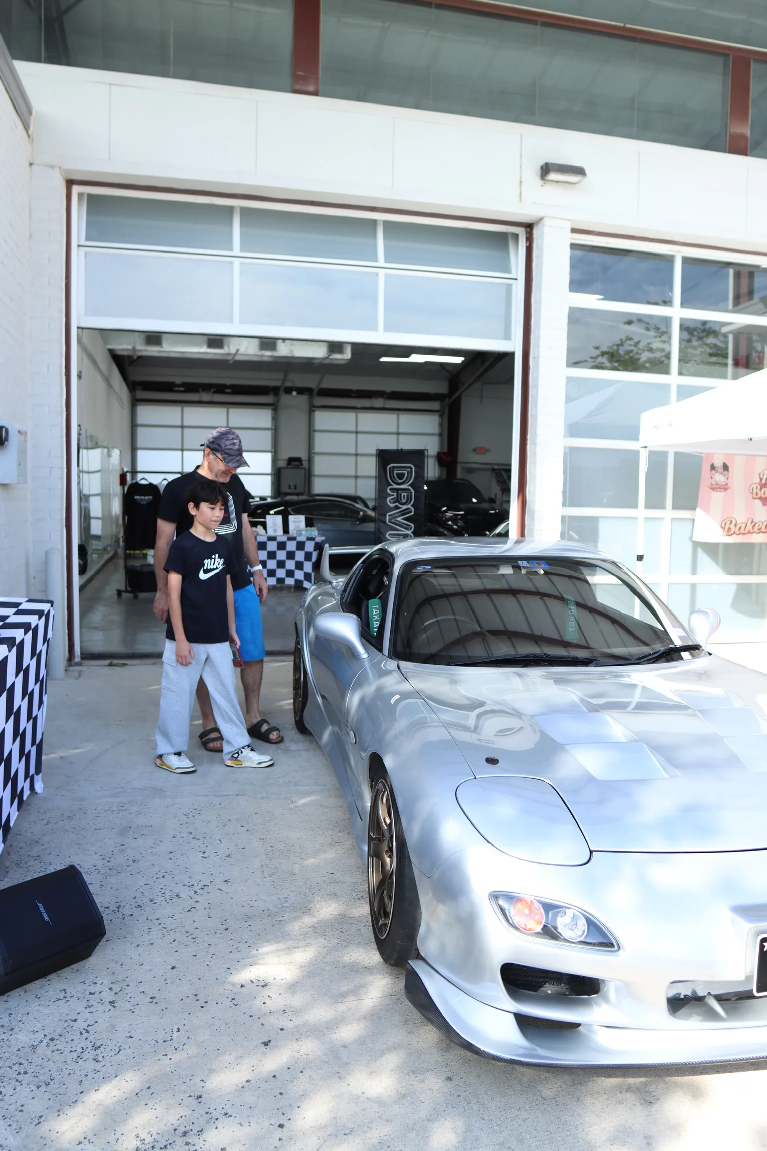 Family looking at a car at Authentic Details
