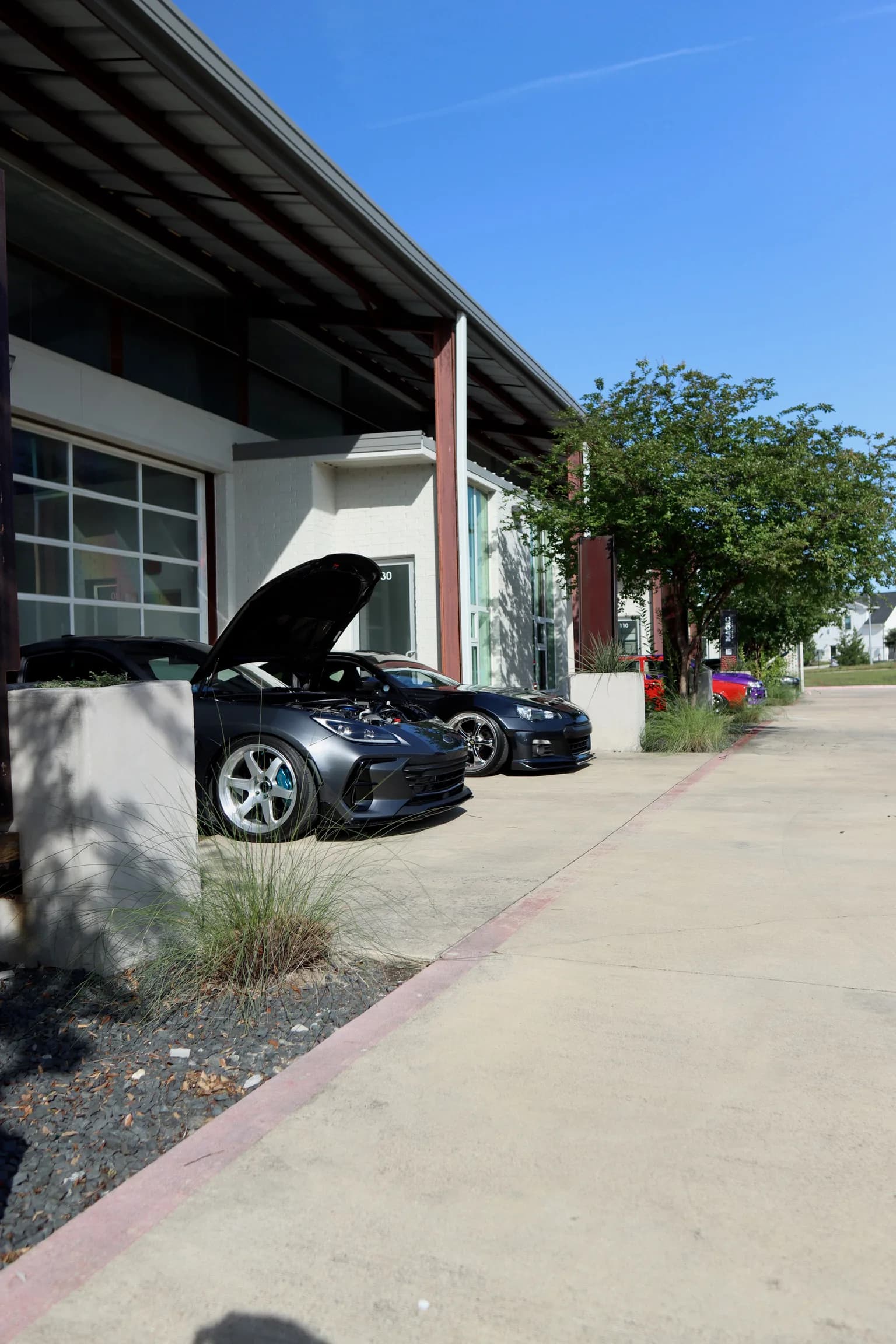 Cars staged outside Authentic Details
