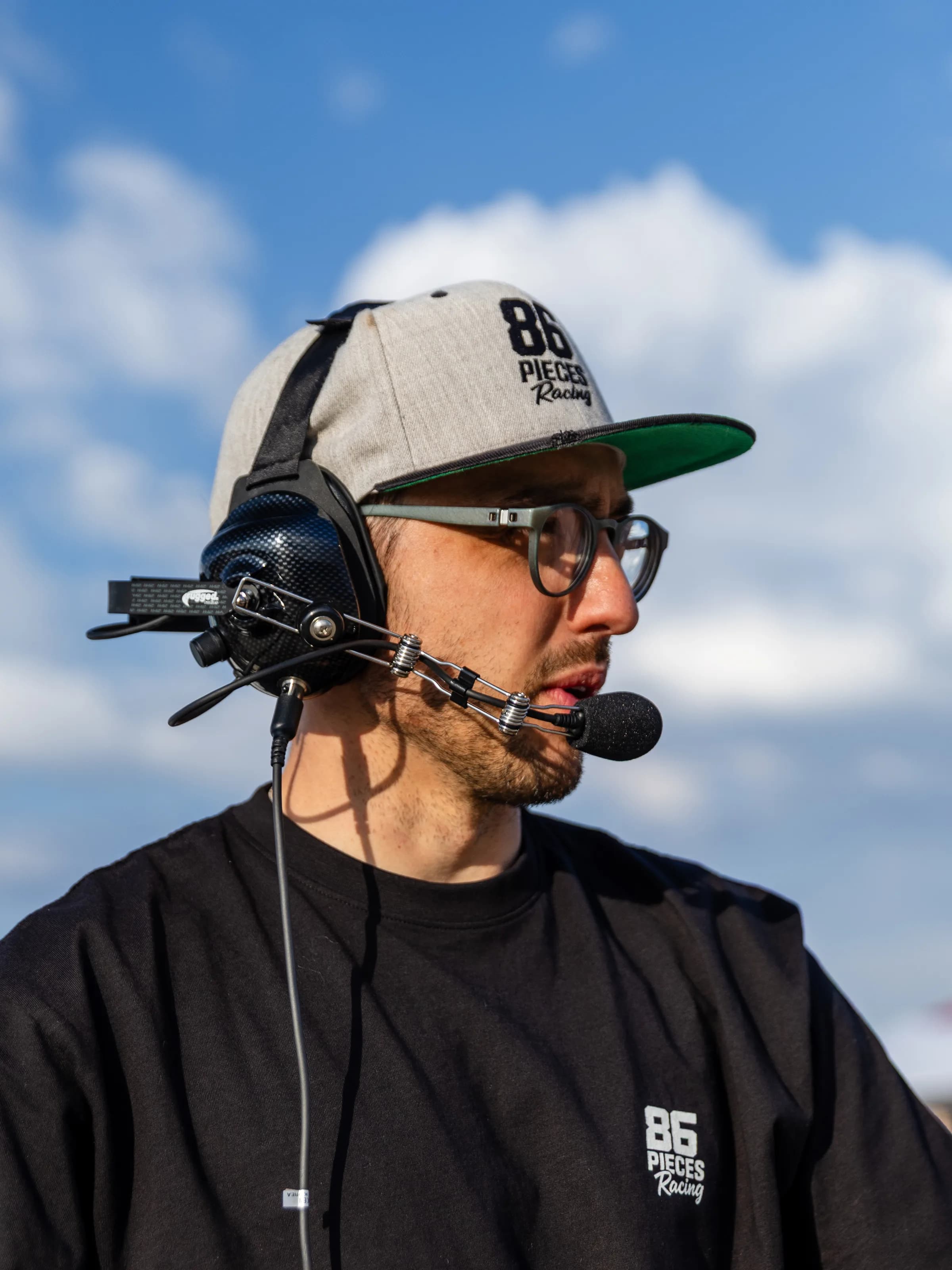 Dan Sabin coaching from the pit wall with a radio headset
