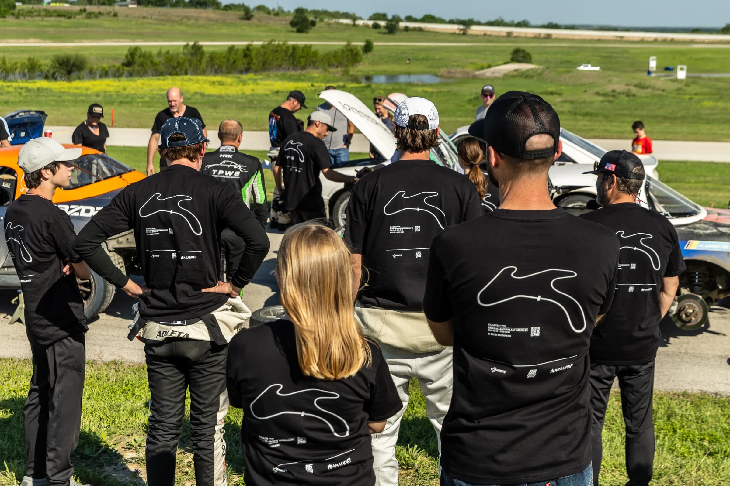 Eighty Six Pieces Racing team wearing black track shirts at race day grid