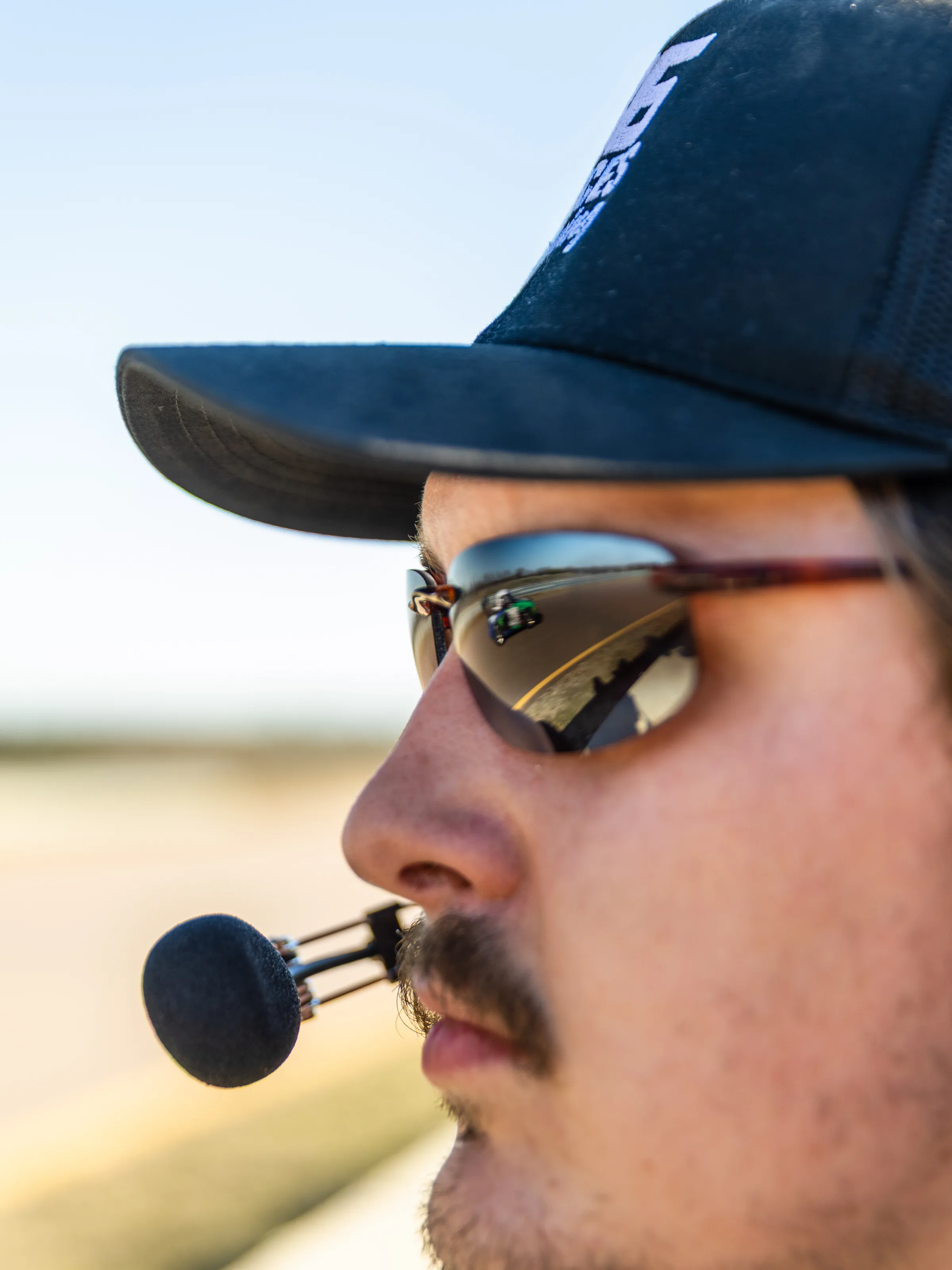 Eighty Six Pieces Racing crew member on radio at the track