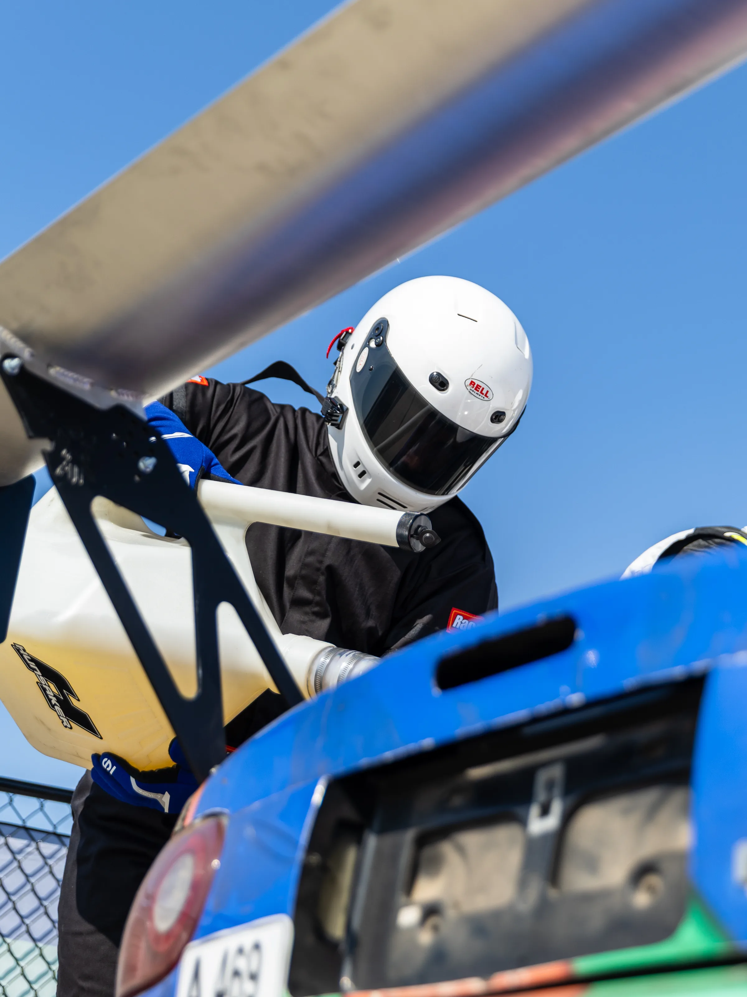 Driver climbing into the Eighty Six Pieces Racing Miata